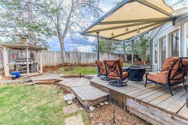 a view of a patio with table and chairs under an umbrella
