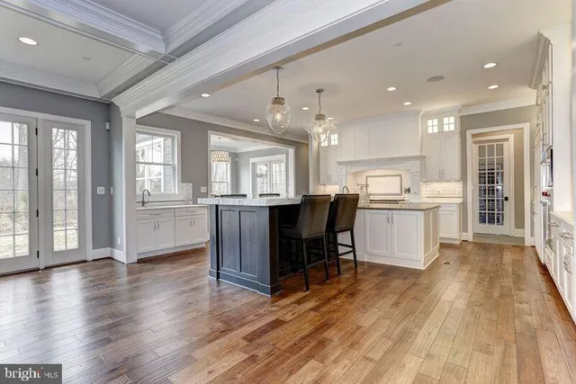 a living room with furniture wooden floor and a large window