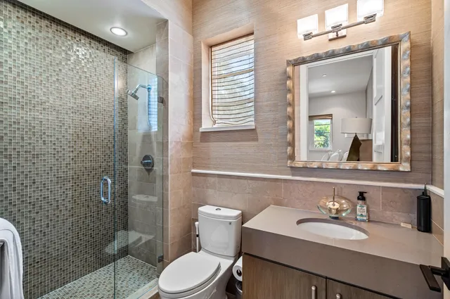 a bedroom with a bed couch and a window