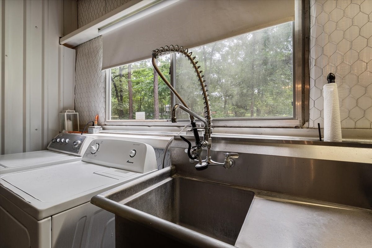 16375 Grand Flower Road Plantersville, TX 77363 - Photo 9 of 50 a view of a sink and a washer and dryer