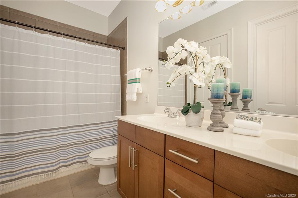 5425 Closeburn Road, Unit 212 Charlotte, NC 28210 - Photo 11 of 14 a bathroom with a sink a toilet and a mirror