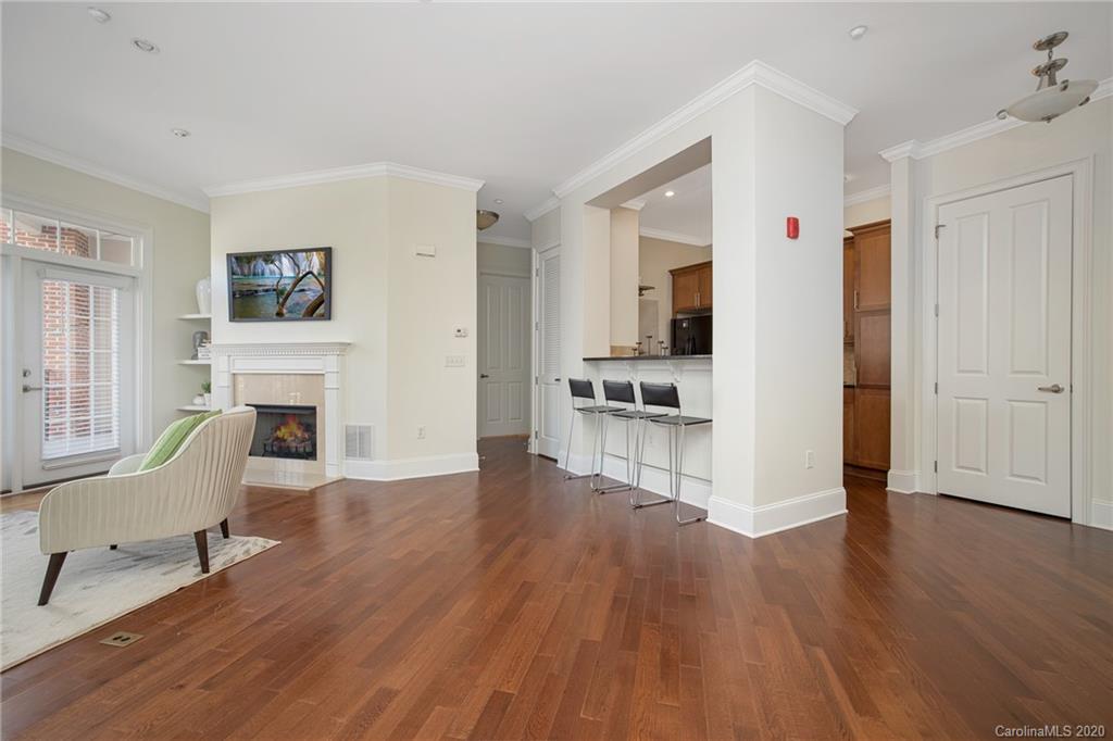 5425 Closeburn Road, Unit 212 Charlotte, NC 28210 - Photo 3 of 14 a living room with furniture wooden floor and a fireplace
