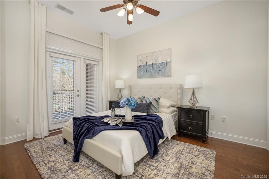 5425 Closeburn Road, Unit 212 Charlotte, NC 28210 - Photo 8 of 14 a bedroom with a bed and a chandelier