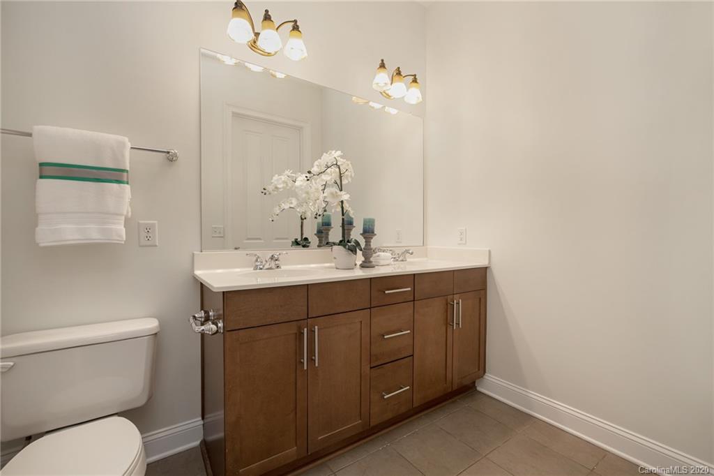 5425 Closeburn Road, Unit 212 Charlotte, NC 28210 - Photo 10 of 14 a bathroom with a toilet a sink and mirror