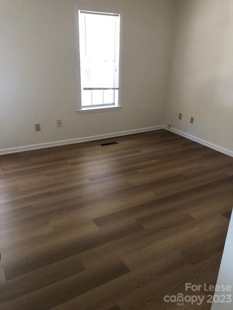 6717 Bevington Ridge Road, Unit A Charlotte, NC 28277 - Photo 12 of 15 an empty room with wooden floor and windows
