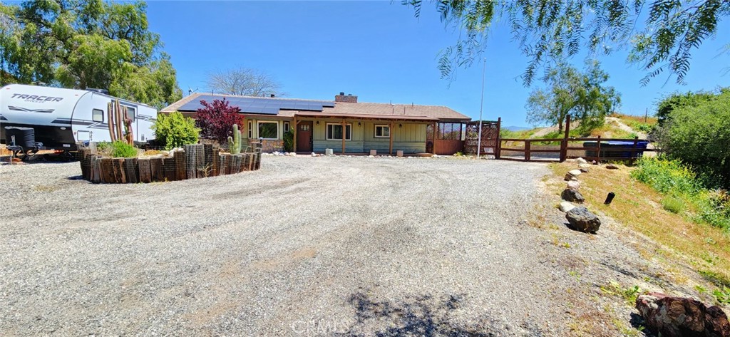 a view of a house with a yard and sitting area