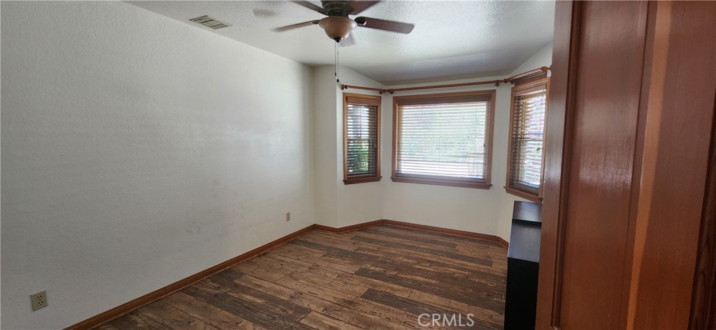 29932 Louis Avenue Canyon Country, CA 91351 - Photo 12 of 46 a view of empty room with wooden floor and fan