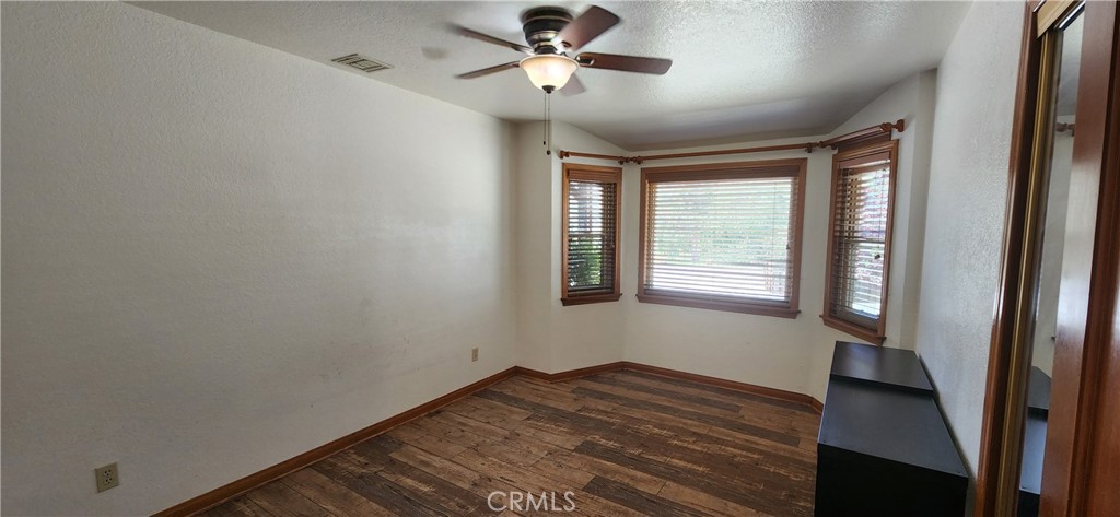 29932 Louis Avenue Canyon Country, CA 91351 - Photo 14 of 46 a view of empty room with wooden floor and fan