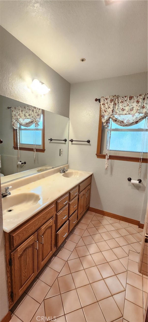 29932 Louis Avenue Canyon Country, CA 91351 - Photo 17 of 46 a spacious bathroom with a sink mirror and vanity