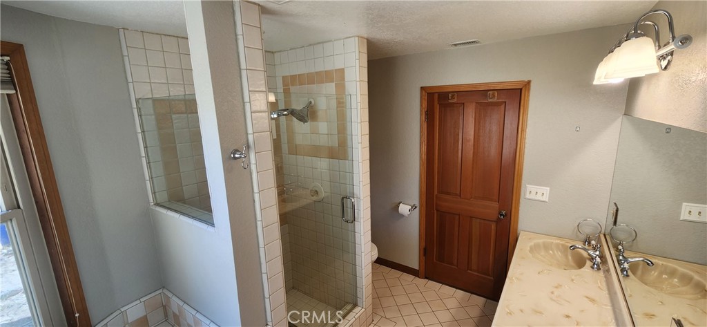 29932 Louis Avenue Canyon Country, CA 91351 - Photo 24 of 46 a bathroom with a tub and shower