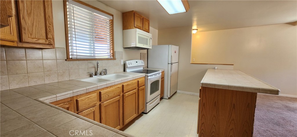 29932 Louis Avenue Canyon Country, CA 91351 - Photo 39 of 46 a kitchen that has a sink and a stove in it