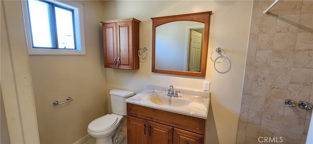 29932 Louis Avenue Canyon Country, CA 91351 - Photo 43 of 46 a bathroom with a granite countertop sink toilet and mirror