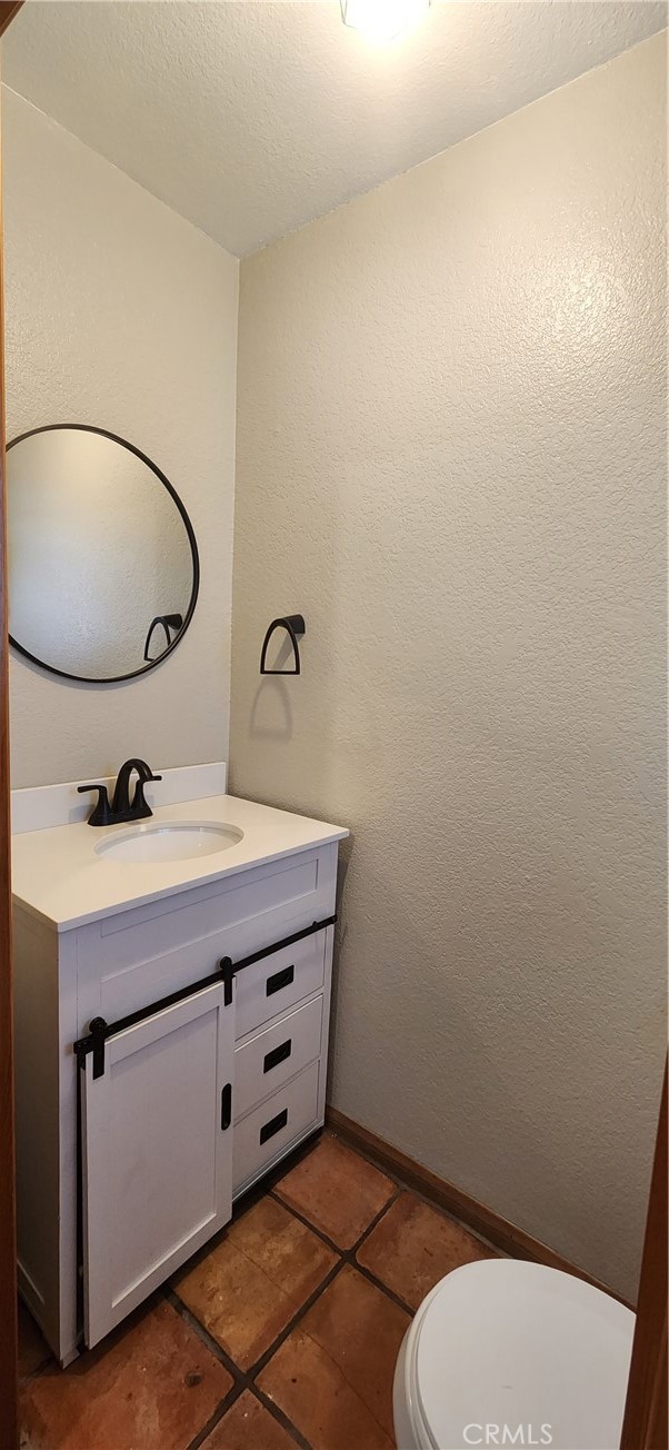 29932 Louis Avenue Canyon Country, CA 91351 - Photo 8 of 46 a bathroom with a toilet a sink and mirror