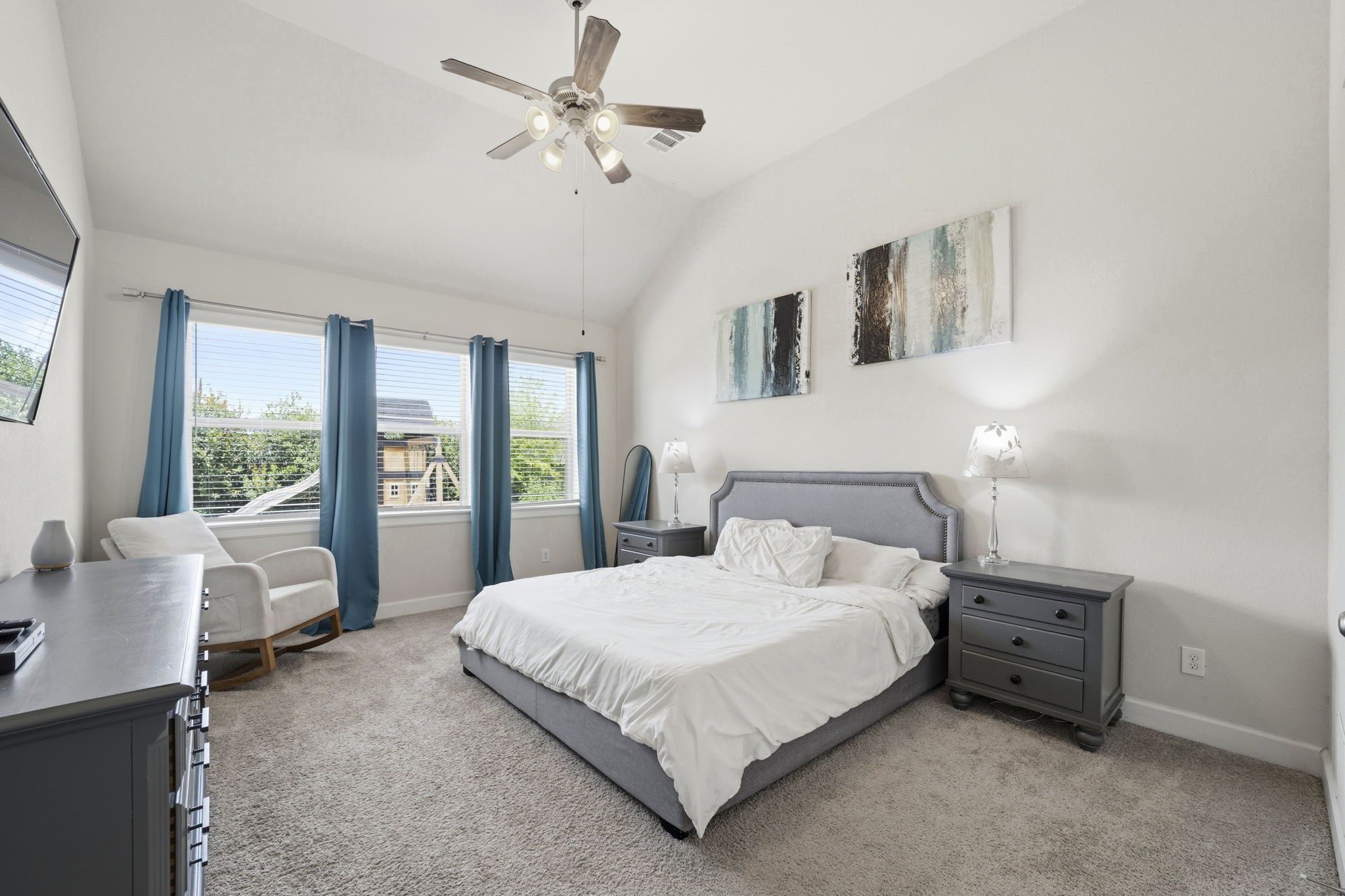 7618 Trailing Oaks Drive Spring, TX 77379 - Photo 16 of 33 a bedroom with a large bed and a chandelier fan