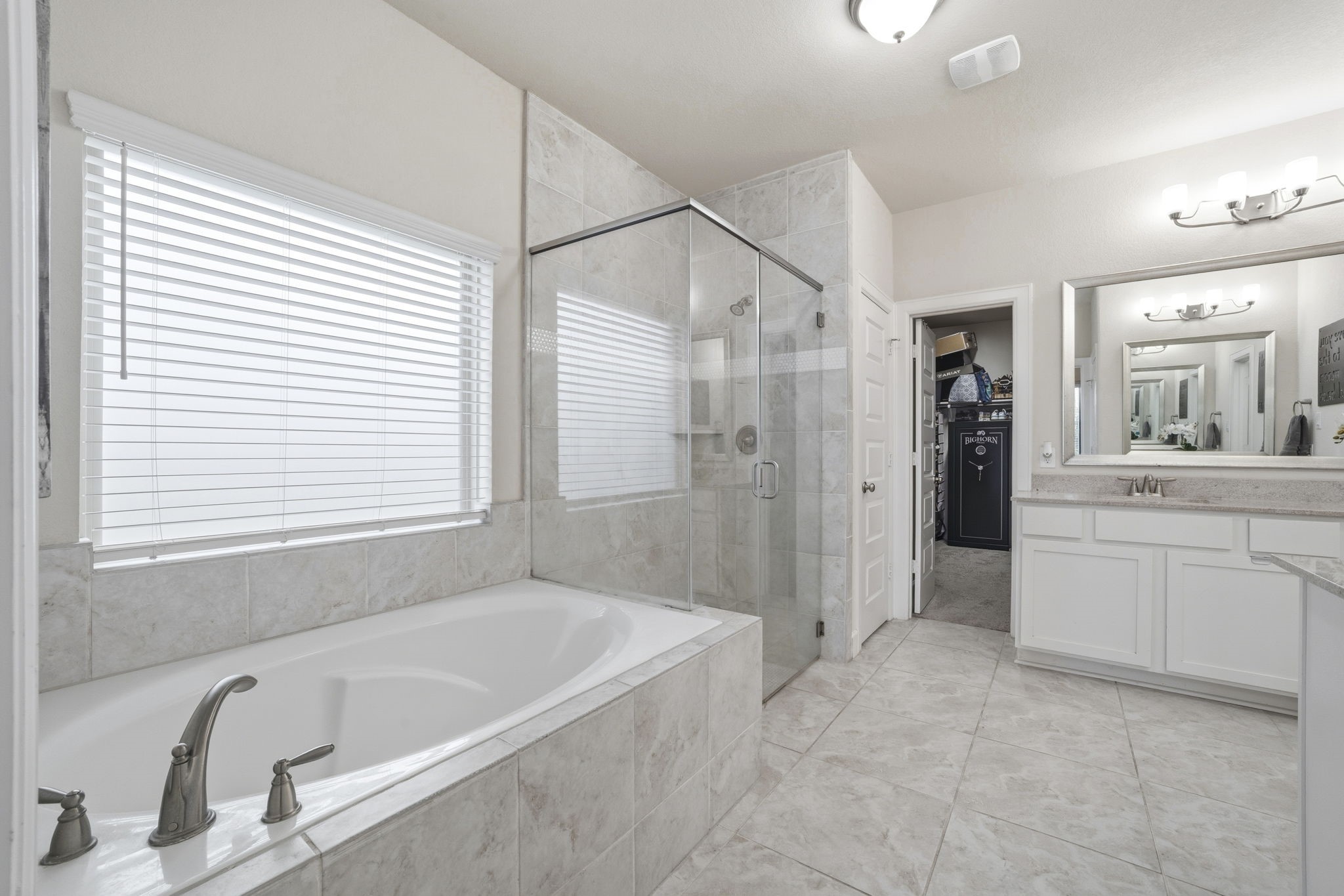7618 Trailing Oaks Drive Spring, TX 77379 - Photo 18 of 33 a bathroom with a tub sink and mirror