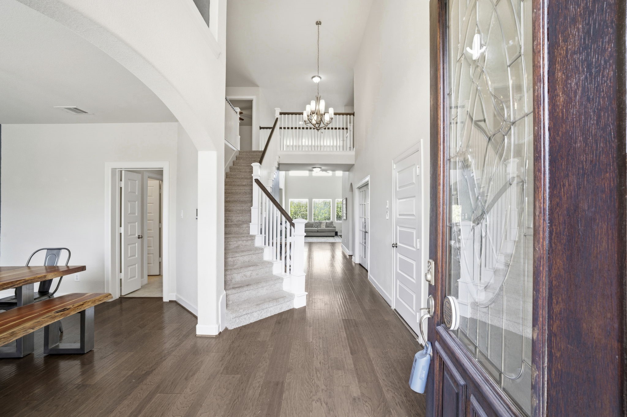 7618 Trailing Oaks Drive Spring, TX 77379 - Photo 2 of 33 a view of a hallway with wooden floor and staircase