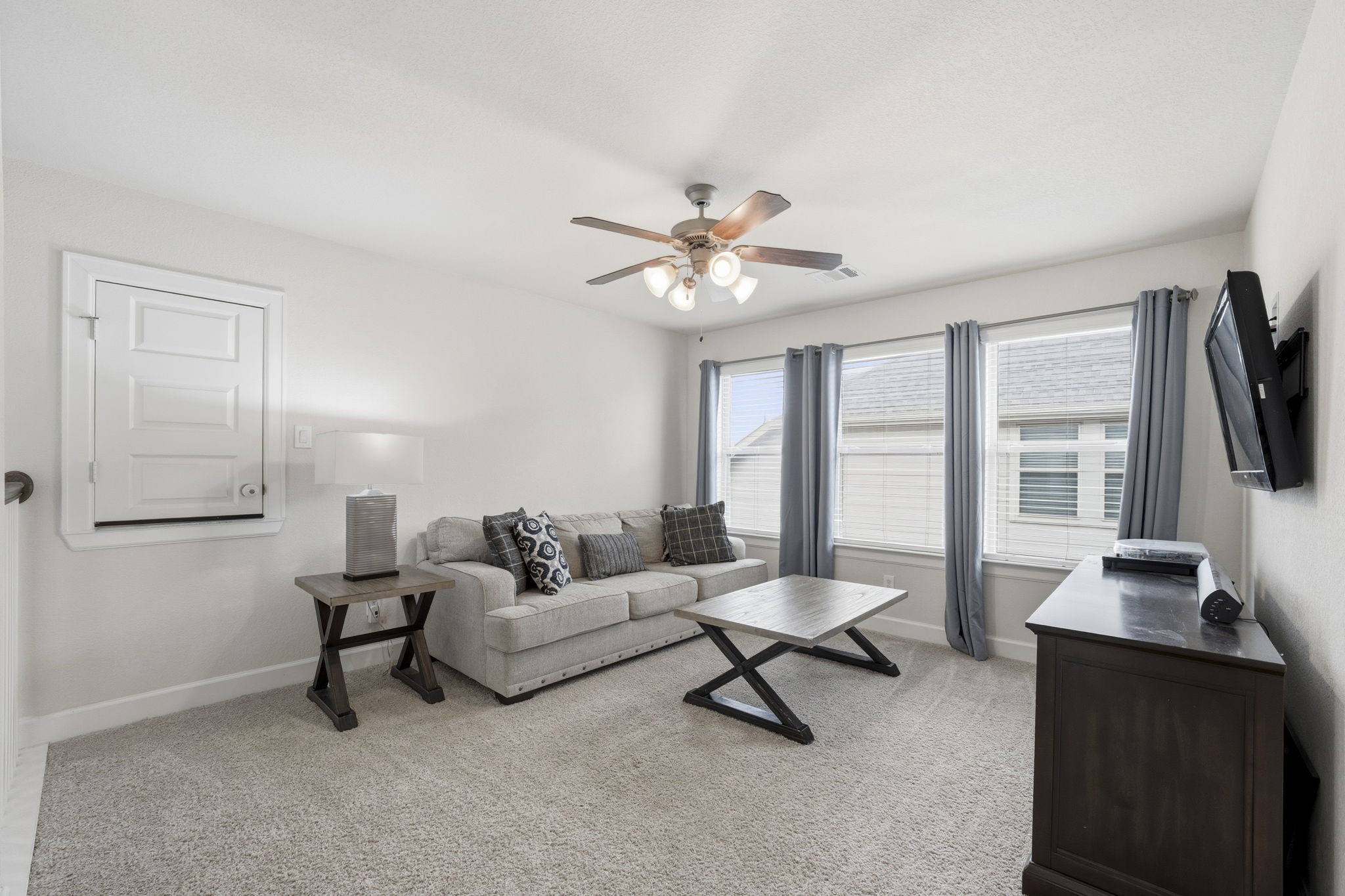 7618 Trailing Oaks Drive Spring, TX 77379 - Photo 22 of 33 a living room with furniture a flat screen tv and a window