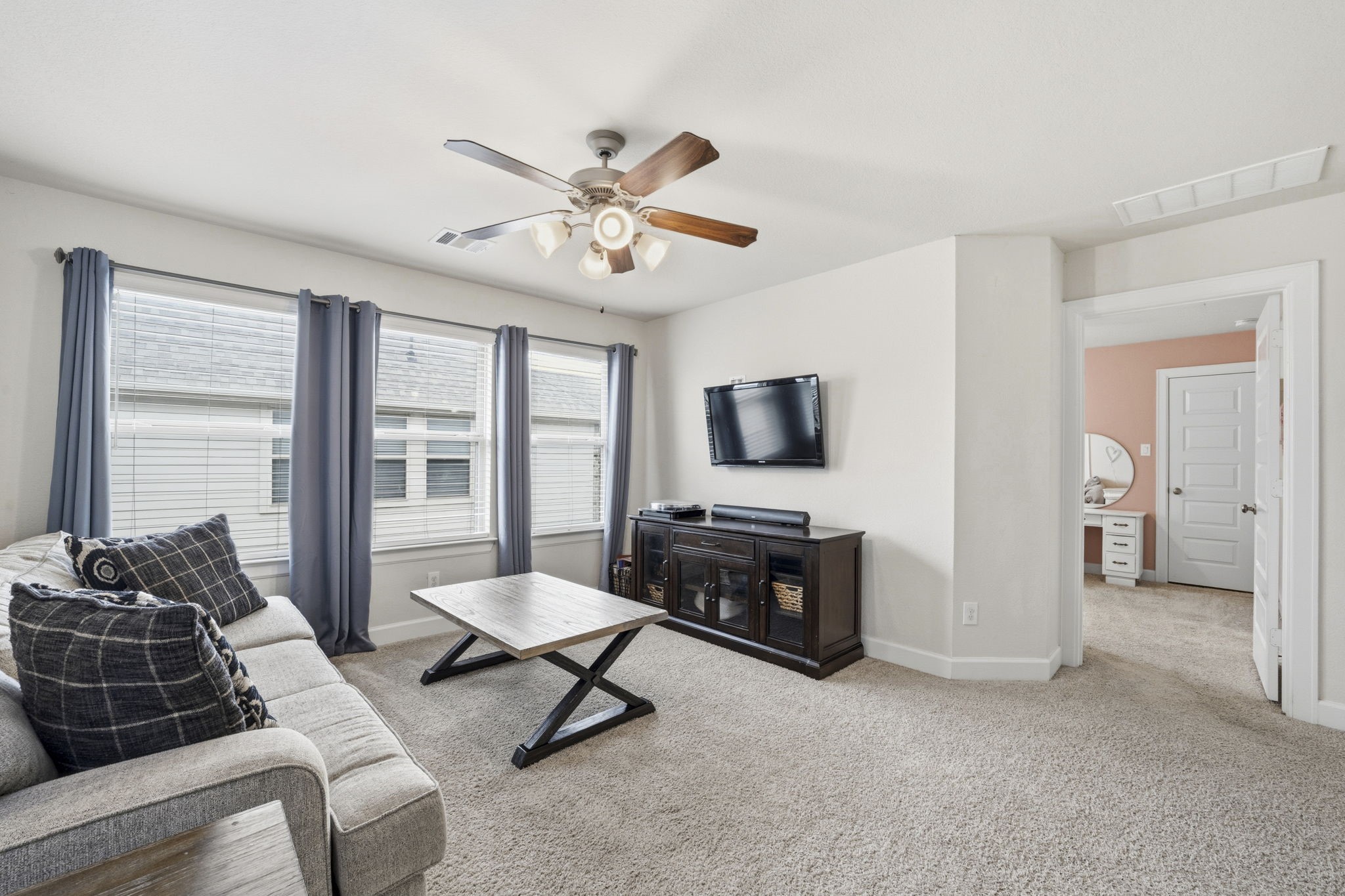 7618 Trailing Oaks Drive Spring, TX 77379 - Photo 23 of 33 a living room with furniture and a flat screen tv
