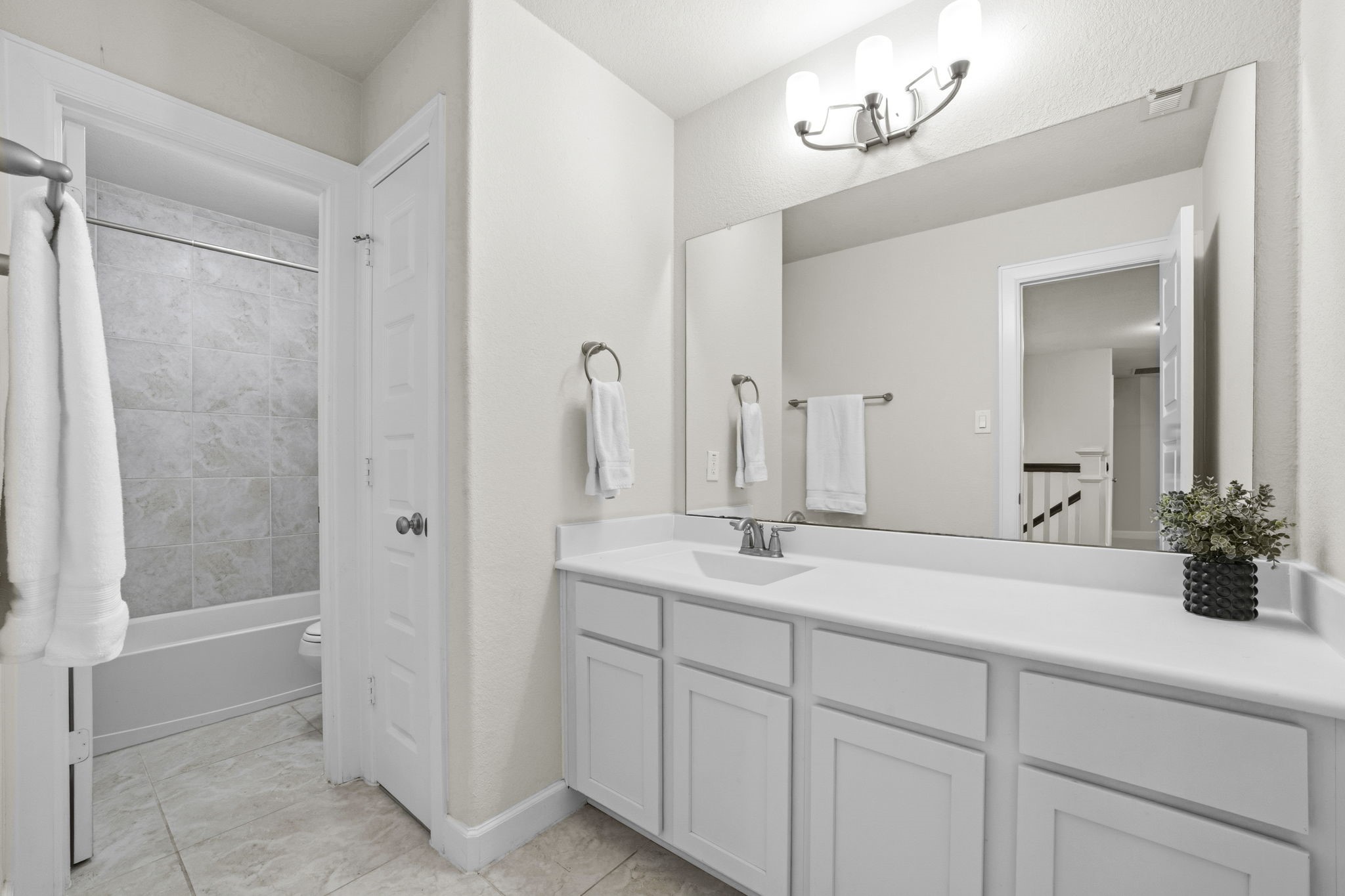 7618 Trailing Oaks Drive Spring, TX 77379 - Photo 28 of 33 a spacious bathroom with a granite countertop sink a mirror and a shower