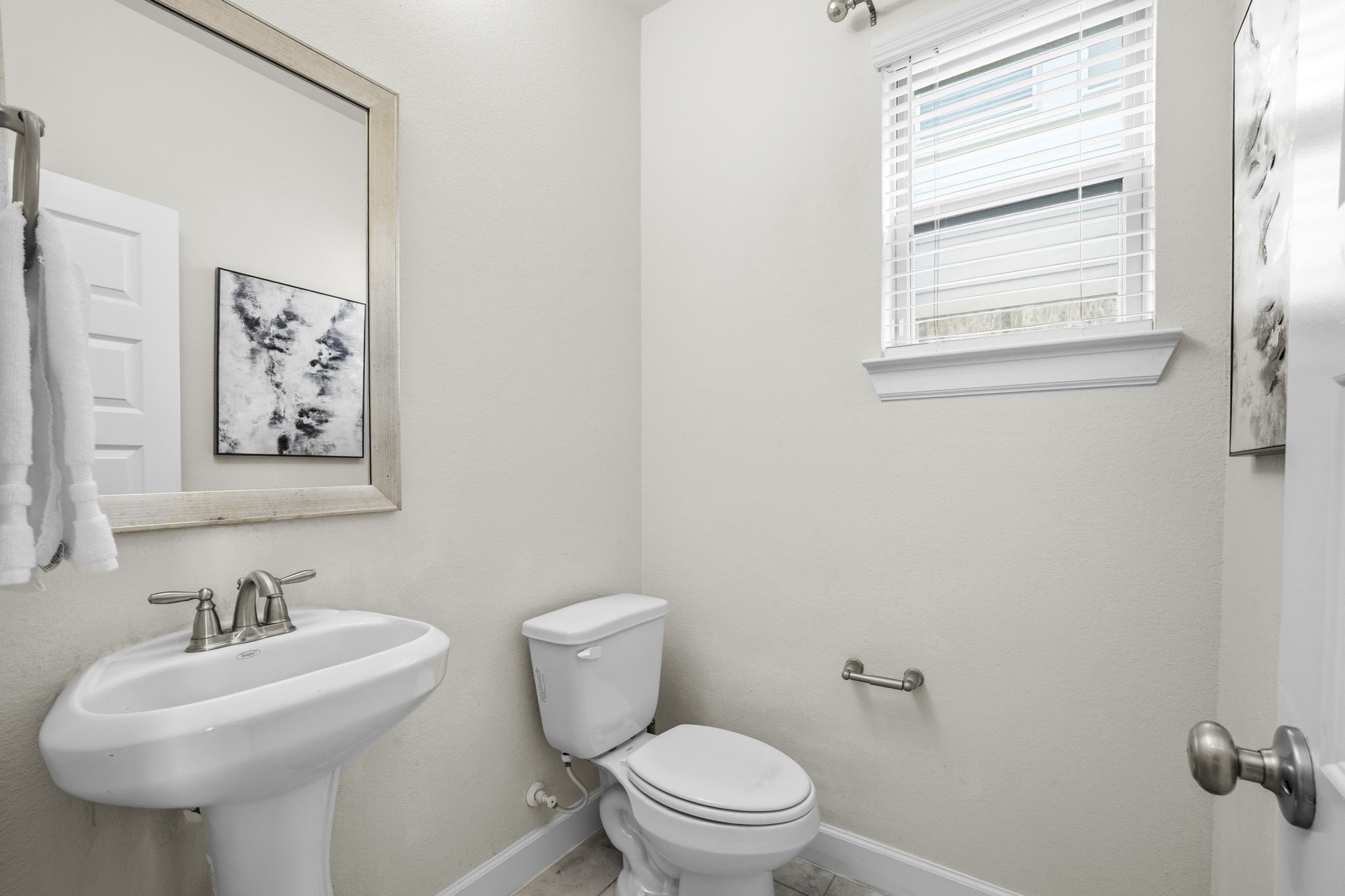 7618 Trailing Oaks Drive Spring, TX 77379 - Photo 8 of 33 a bathroom with a toilet sink and mirror