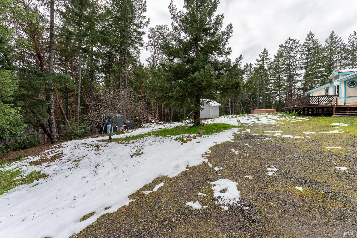 5751 Ridgewood Road Willits, CA 95490 - Photo 19 of 27 a backyard of a house with basket ball court tables and chairs