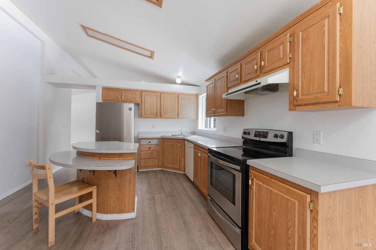 5751 Ridgewood Road Willits, CA 95490 - Photo 5 of 27 a kitchen with stainless steel appliances a stove a sink dishwasher and wooden cabinets with wooden floor