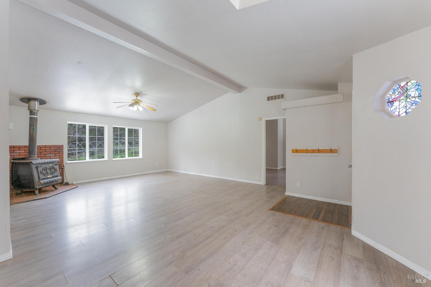 5751 Ridgewood Road Willits, CA 95490 - Photo 6 of 27 an empty room with wooden floor and windows