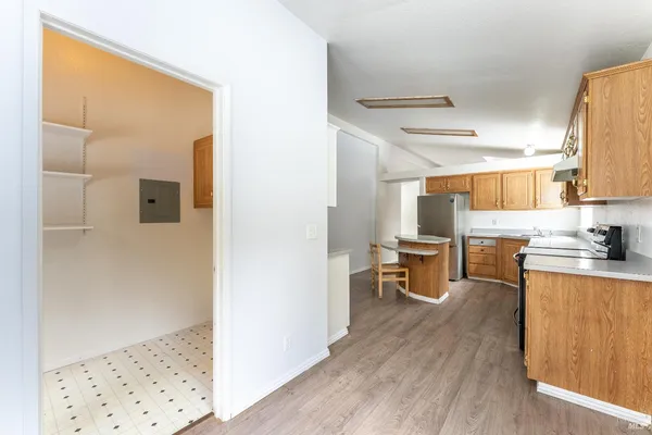 a kitchen view with wooden floor and a window