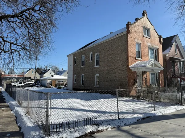 a front view of a house with iron fence