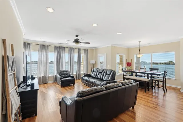 a living room with furniture wooden floor and a view of kitchen