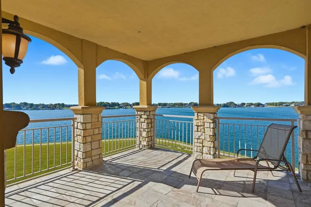 a view of a chairs and table in the balcony