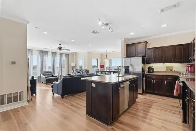 a large kitchen with stainless steel appliances granite countertop a large center island and a sink