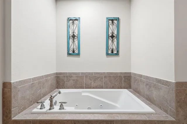 a bathroom with bathtub and window