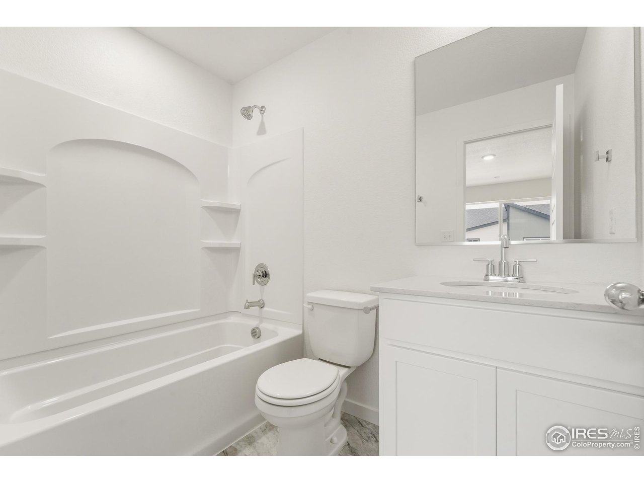 3912 Net Street Evans, CO 80620 - Photo 12 of 19 a bathroom with a sink a toilet and a bathtub