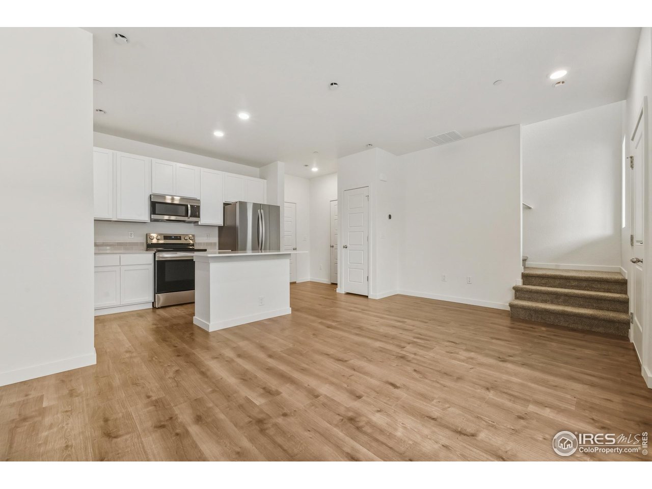 3912 Net Street Evans, CO 80620 - Photo 4 of 19 a view of kitchen and wooden floor