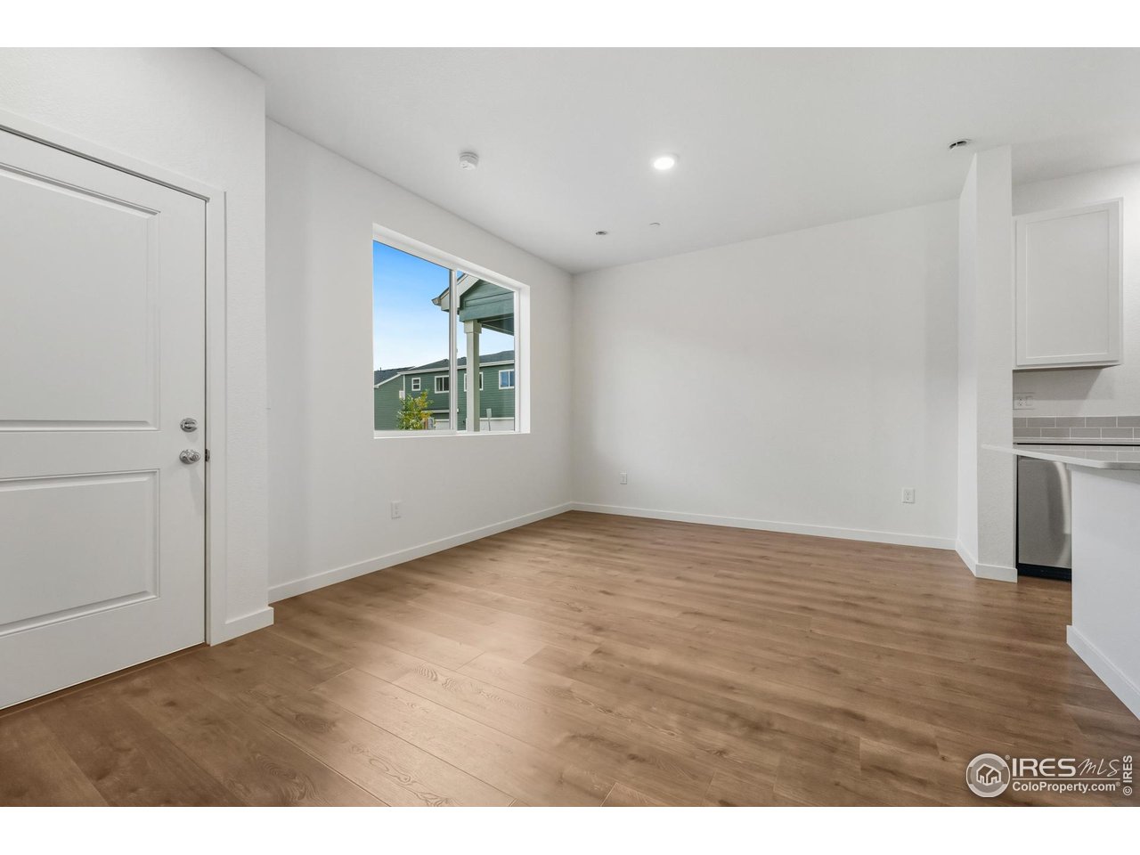 3912 Net Street Evans, CO 80620 - Photo 5 of 19 a view of an empty room with wooden floor and a window