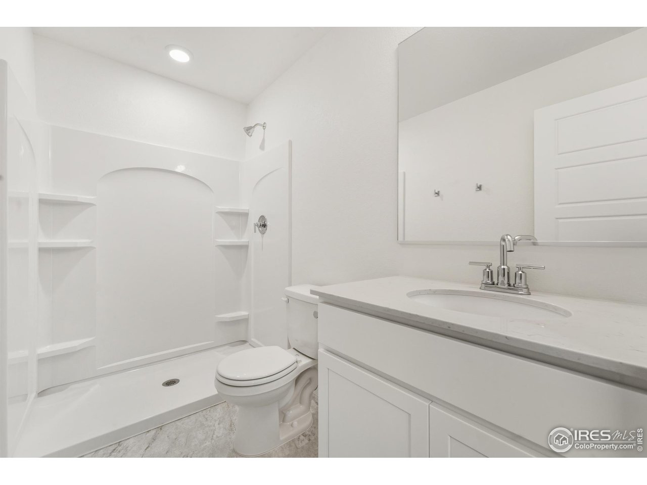 3912 Net Street Evans, CO 80620 - Photo 8 of 19 a bathroom with a granite countertop sink a toilet and shower