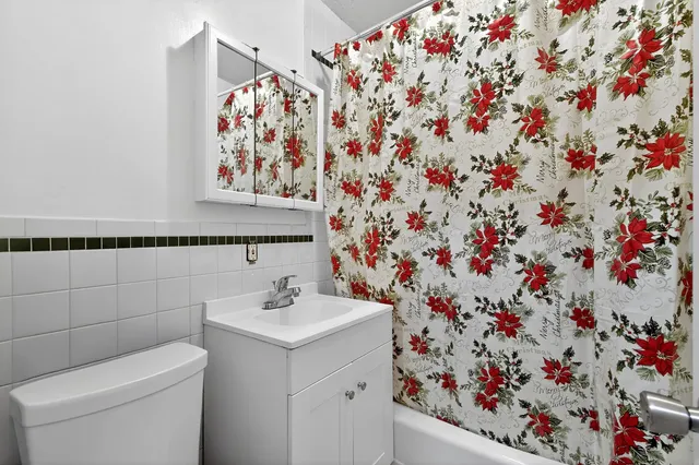 a bathroom with a sink and mirror with toilet
