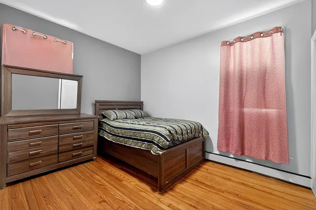 a bedroom with a bed and a dresser