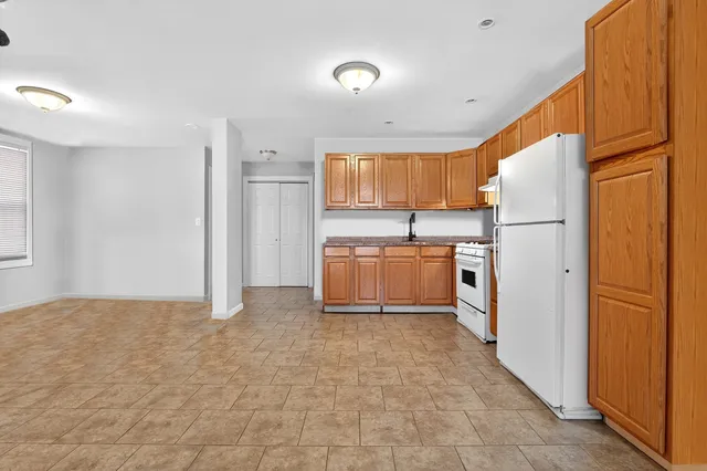 a kitchen with stainless steel appliances granite countertop a refrigerator sink and cabinets