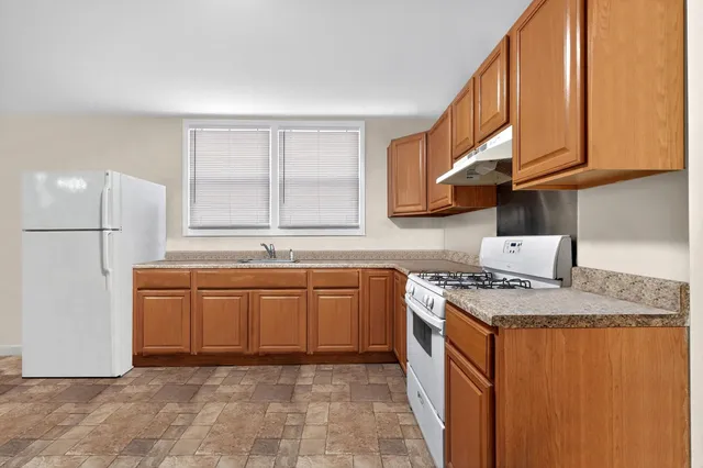 a kitchen with stainless steel appliances granite countertop a sink and a stove