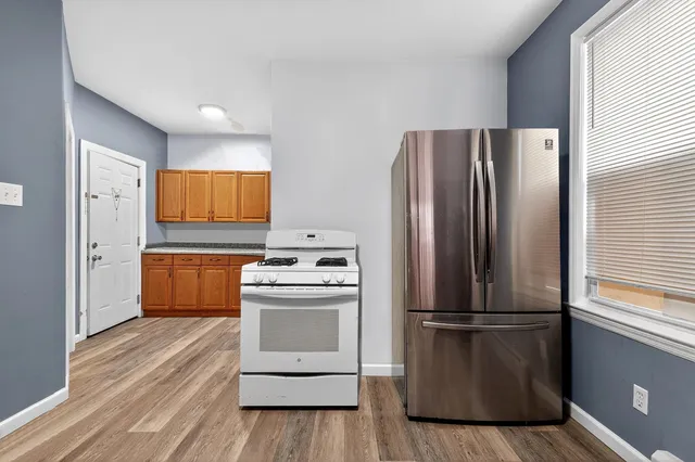 a kitchen with stainless steel appliances a refrigerator and a stove top oven