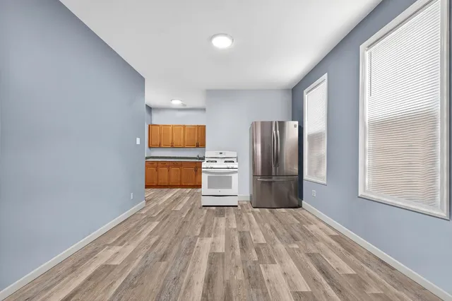 a kitchen with granite countertop white cabinets and stainless steel appliances