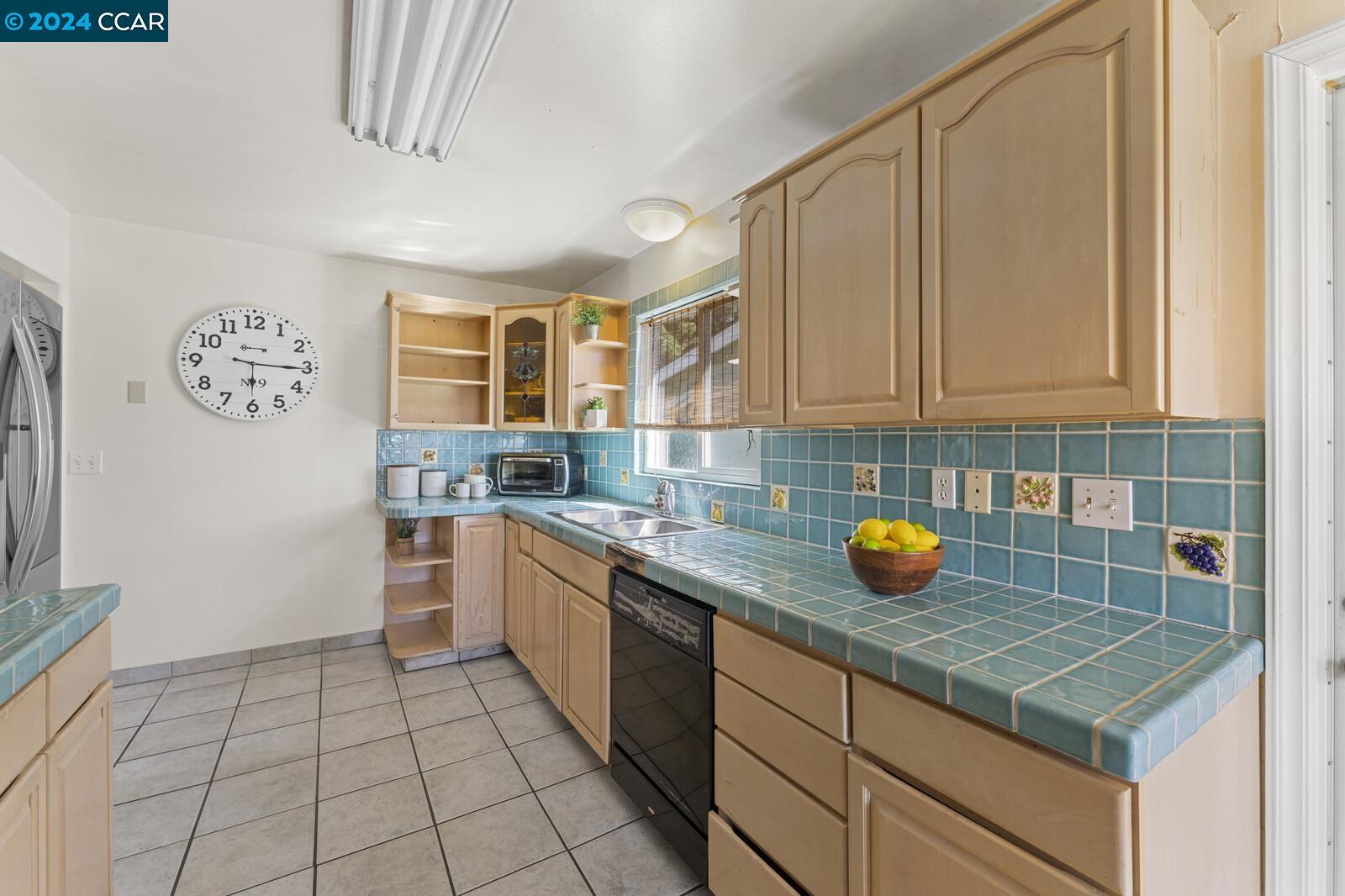 Undisclosed Address Richmond, CA 94805 - Photo 18 of 47 a kitchen with a sink and cabinets