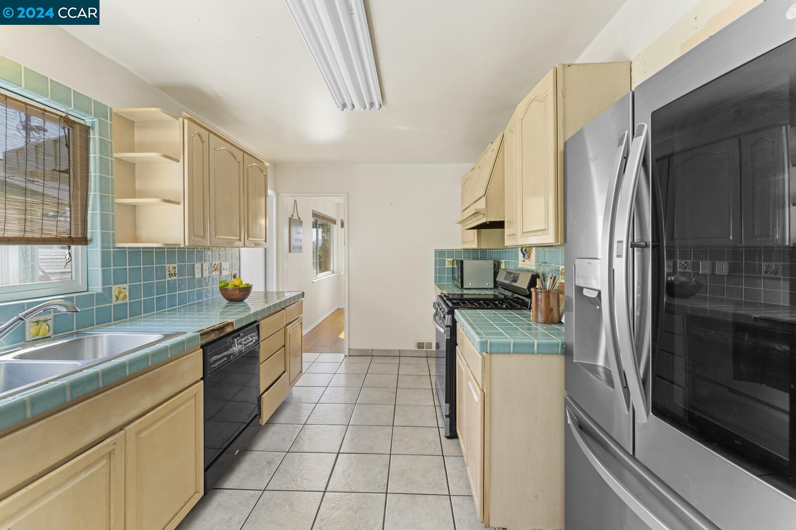 Undisclosed Address Richmond, CA 94805 - Photo 19 of 47 a kitchen with stainless steel appliances granite countertop a refrigerator and a sink