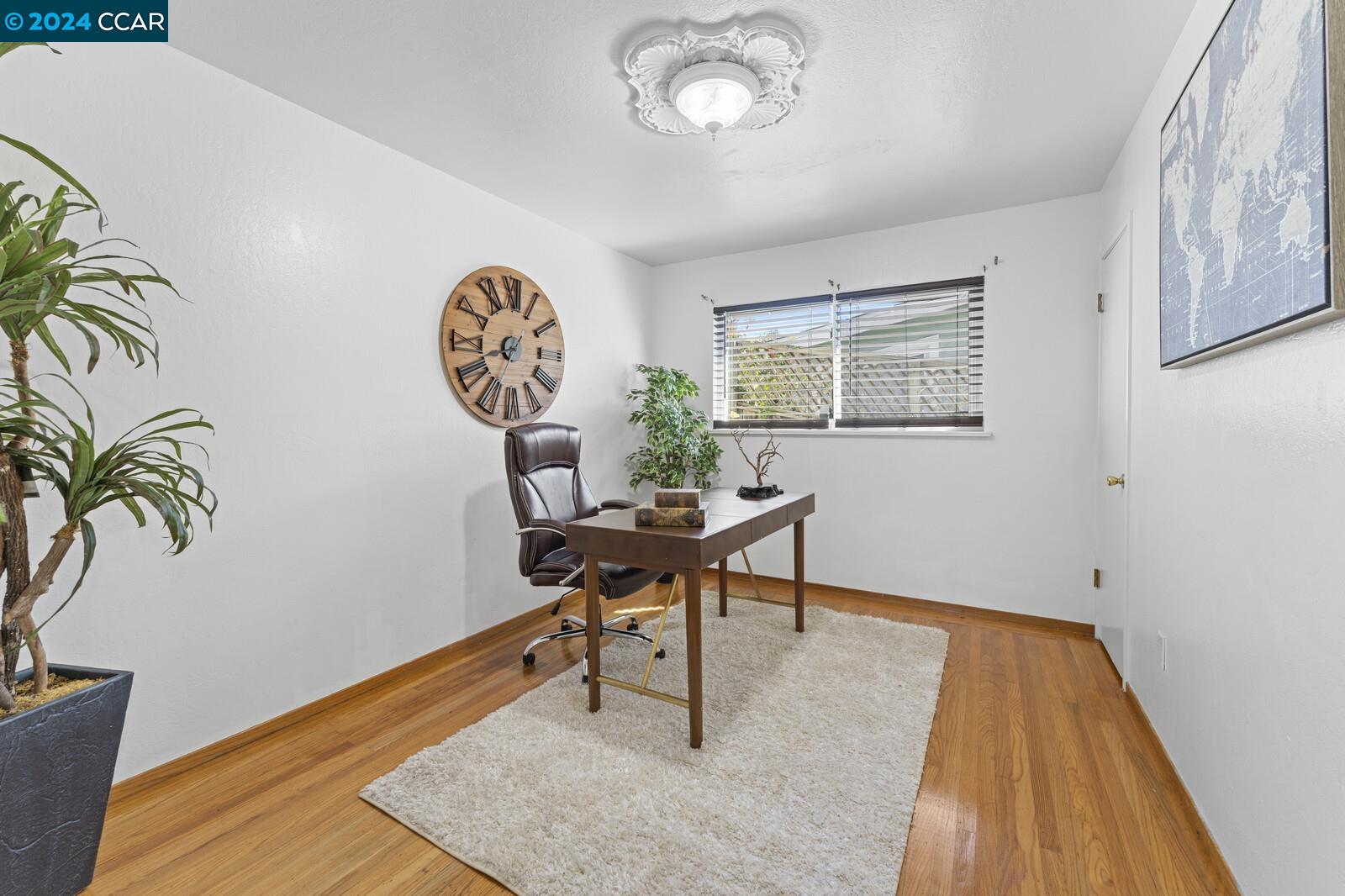 Undisclosed Address Richmond, CA 94805 - Photo 25 of 47 a workspace room with furniture and wooden floor