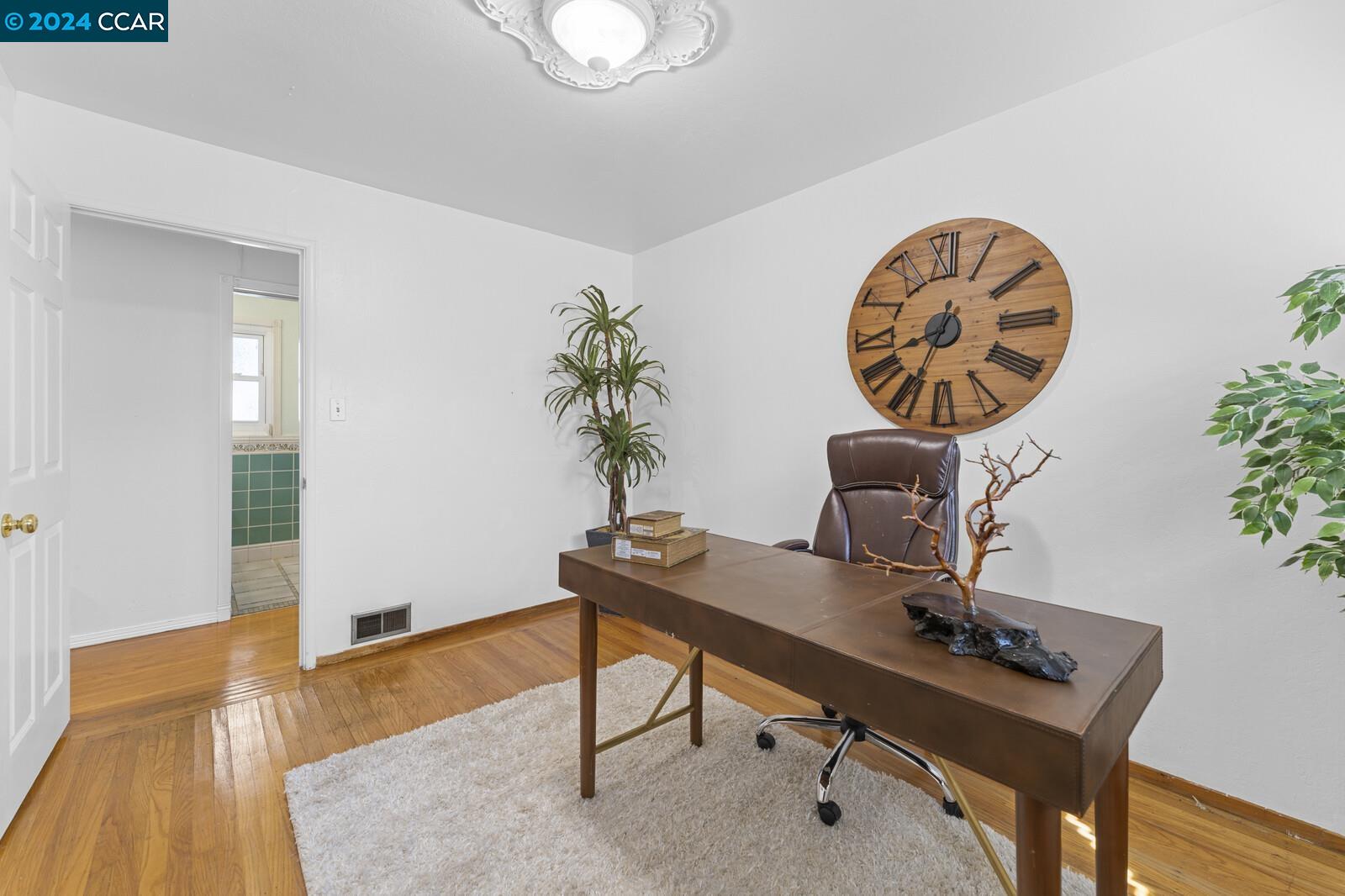 Undisclosed Address Richmond, CA 94805 - Photo 26 of 47 a view of a workspace with a table and a potted plant