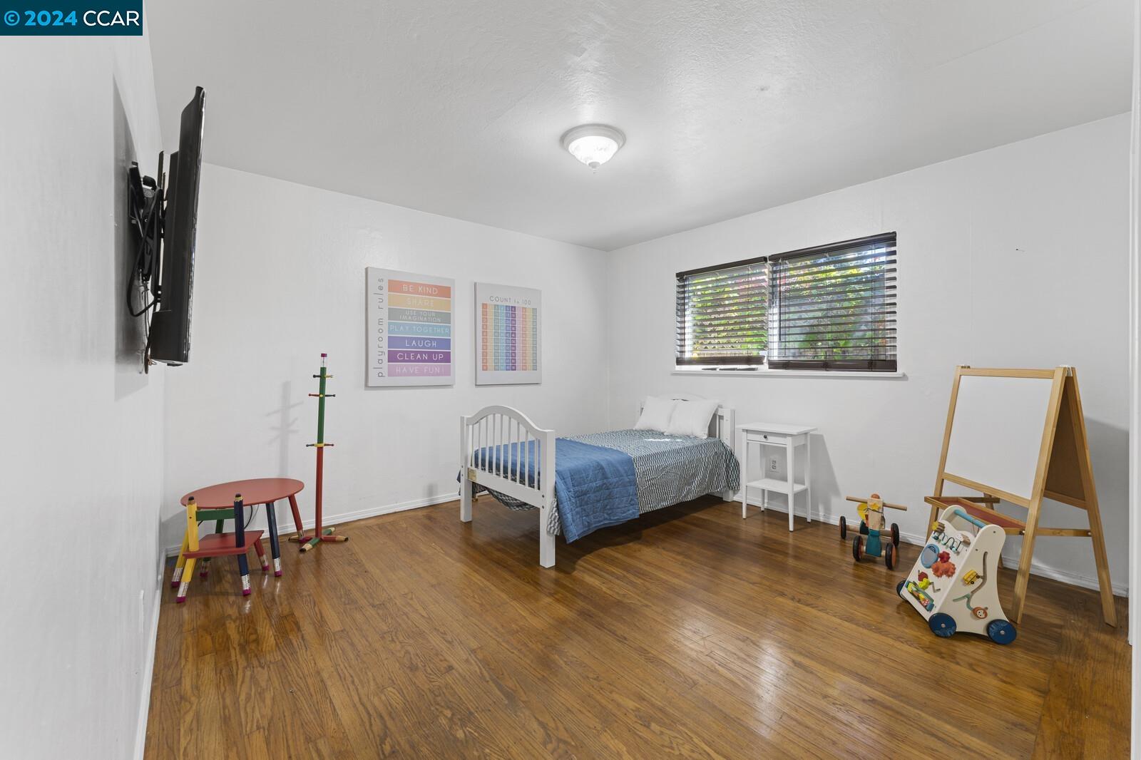 Undisclosed Address Richmond, CA 94805 - Photo 27 of 47 a living room with furniture and a wooden floor