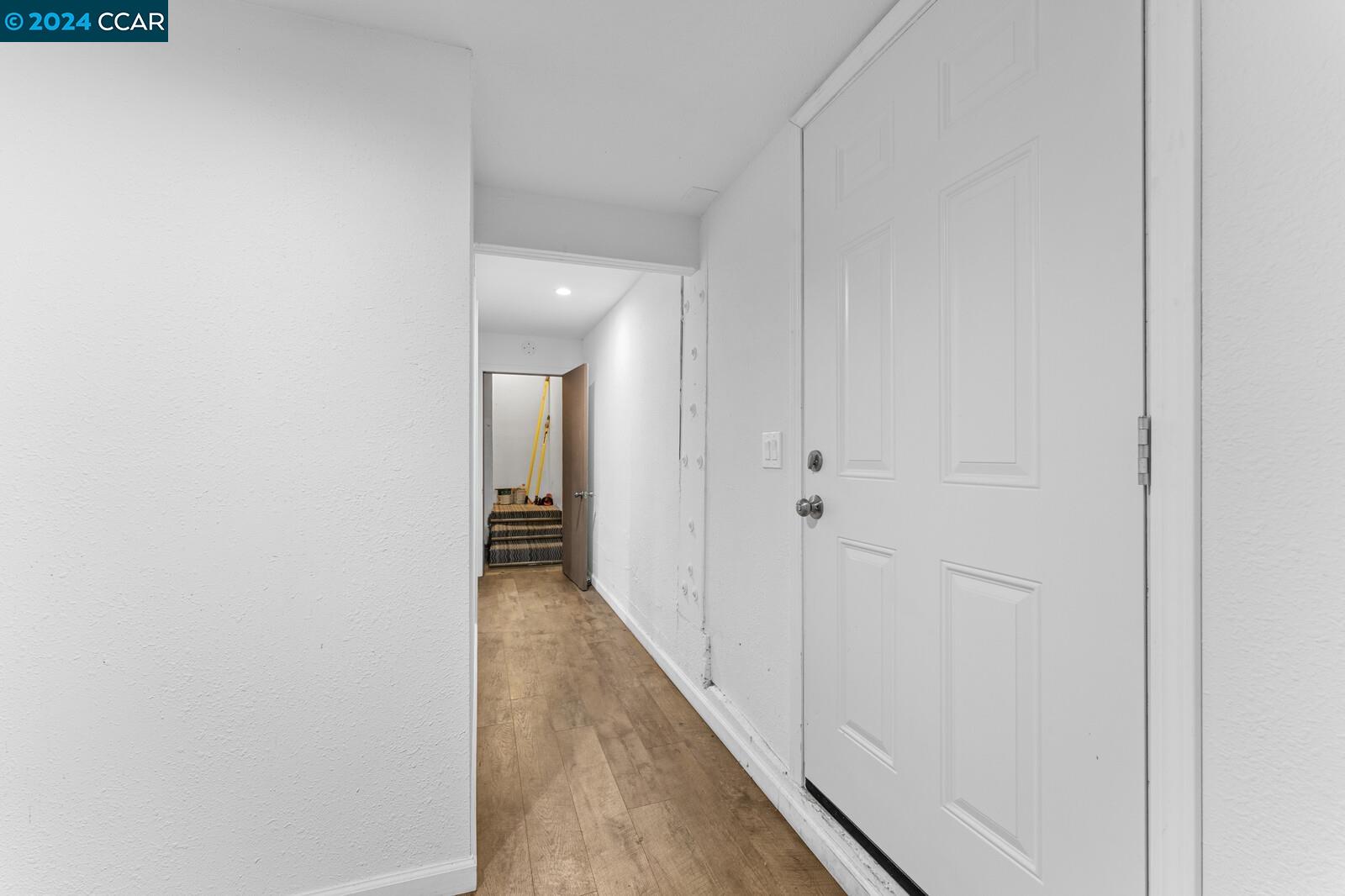 Undisclosed Address Richmond, CA 94805 - Photo 30 of 47 a view of a hallway with wooden floor