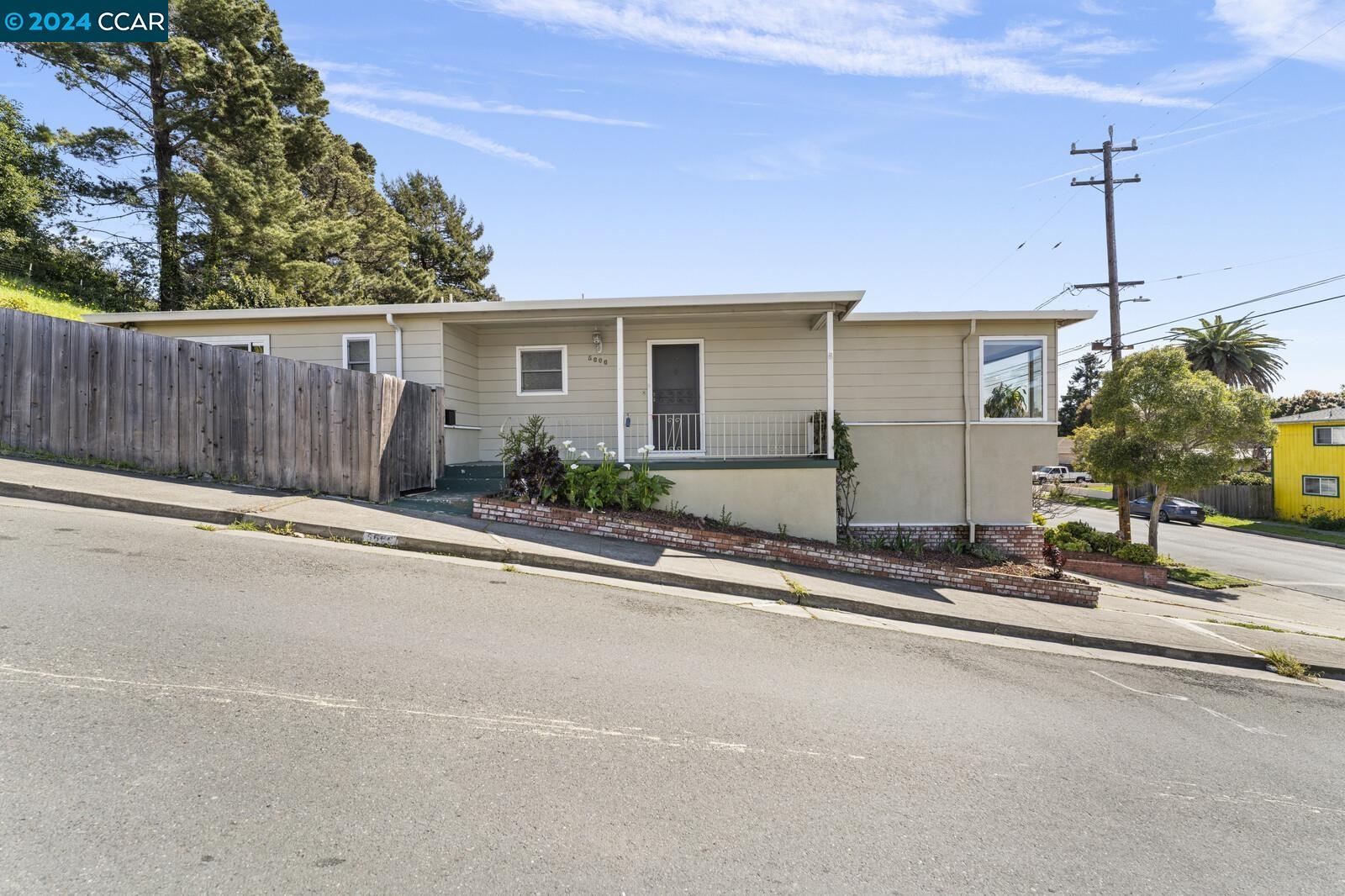 Undisclosed Address Richmond, CA 94805 - Photo 3 of 47 front view of a house with a street